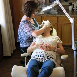 Pam Edmonson of Creative Permanent Makeup By Pam works on a client at All About You Salon in Zephyrhills.