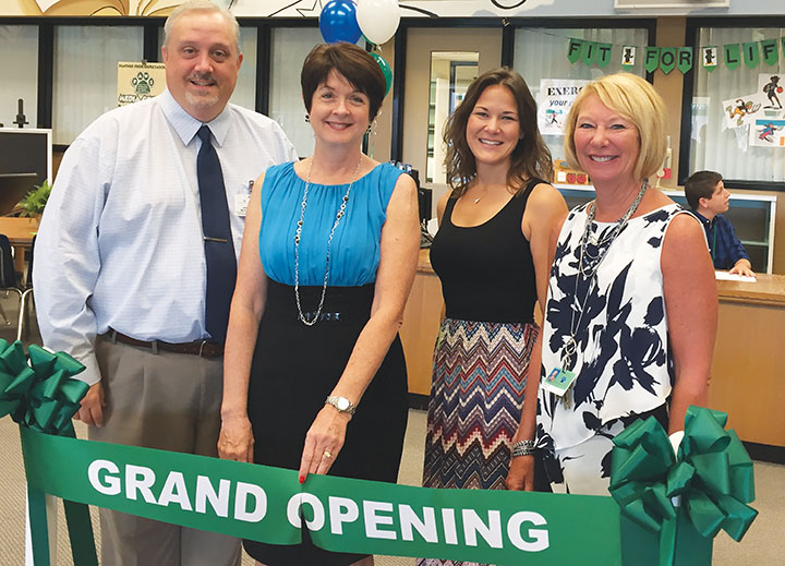 The ribbon was cut by (left to right) Hillsborough Country Public Schools supervisor of library media services for K-5 John Milburn, Elliott, HGE PTA president Jamie Priest and principal Gaye Holt.